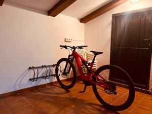 a red bike is parked in a room at Villa Revolcona in La Adrada