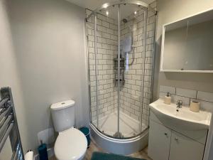 a bathroom with a shower and a toilet and a sink at Spot Chambers in Derby