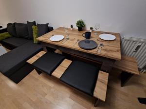 a dining room table with chairs and a couch at Schönbrunn Gardens Vienna Apartment in Vienna