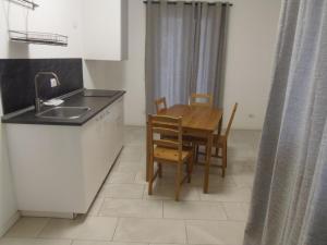 a kitchen with a table and chairs and a sink at Apartaments and Rooms Claudia Augusta in Bolzano