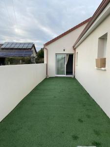 an empty backyard with a green lawn at Villa by Nesma in Châtellerault