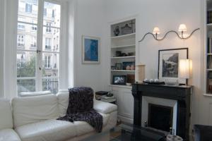 パリにあるDream Catcher 3Bdr Paris apartmentのリビングルーム(白いソファ、暖炉付)