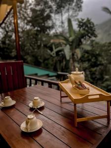 a wooden table with a tea set on top of it at Haven Harbour in Ella