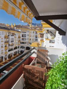 a balcony with a bench and views of buildings at Apartamento Centro Marbella in Marbella