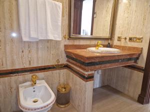 a bathroom with a sink and a toilet and a mirror at Apartamento Centro Marbella in Marbella +32 photos