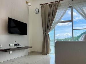 un salon avec une grande fenêtre et une horloge dans l'établissement Comfy 2 Bedder Retreat Homestay near Taiping Lake Garden with Netflix, à Taiping