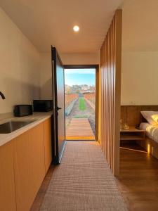 a kitchen with a door leading to a room with a view at Quinta de Requeixo in Guimarães