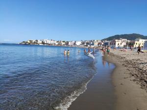 a group of people playing in the water on a beach at Hotel Da Raffaele in Ischia