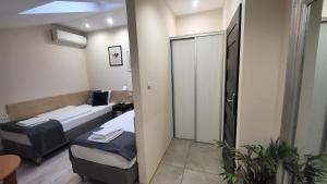 ein kleines Zimmer mit 2 Betten und einem Spiegel in der Unterkunft Aparthotel Riva in Zawiercie