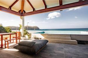 a bedroom with a view of the ocean at CASA ROSA 49’ - Playa Venao Beach in Playa Venao