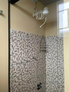 a shower with a glass door in a bathroom at Apto 1 ótimo local próximo shopping in Campo Grande