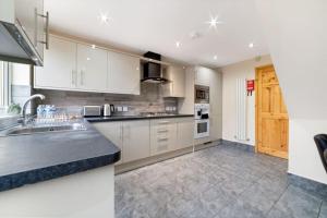 a kitchen with white cabinets and a counter top at Professionals,Contractors,Family in Leicester