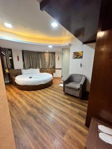 a hotel room with a bed and a chair at Hotel the pacific Chakala in Mumbai