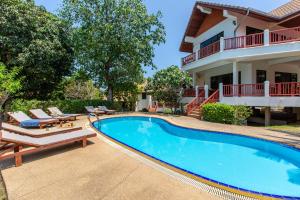 a swimming pool in front of a house at Viewpoint Residence 2 Bedroom Villa in Koh Samui 