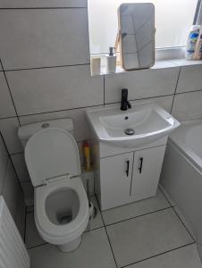 a small bathroom with a toilet and a sink at Modern 3 bedroom home, close to City Centre and Peak District in Heeley