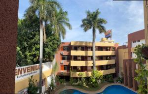 un hôtel avec des palmiers devant un bâtiment dans l'établissement Quinta Mar, à Ciudad Valles