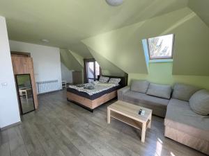 a living room with a couch and a table at ZaraApartHotel in Sofia