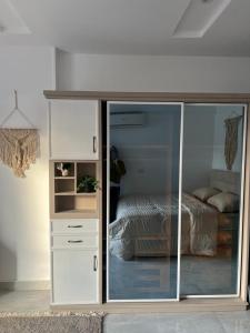 a bedroom with a bed and a sliding glass door at 127-3 النيل in Cairo