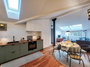 a kitchen and living room with a table and chairs at Villa Ines in Riva del Garda
