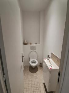 a small bathroom with a toilet and a sink at *Appartement Moderne/2 minutes du métro* in Saint-Ouen