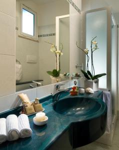 a bathroom with a blue sink and a mirror at Hotel Riviera B&B in Misano Adriatico