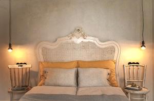 1 cama con cabecero ornamentado en un dormitorio en Kis Vulkán Nyúlontúl, en Mencshely