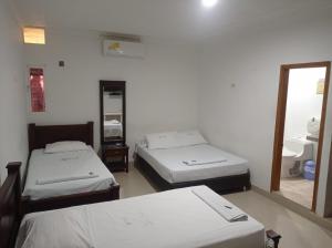 Postel nebo postele na pokoji v ubytování Hotel Damys