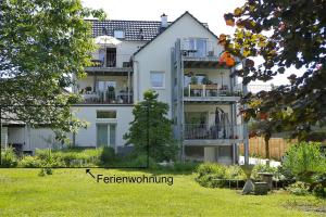 a large white building with a lawn in front of it at Ferienwohnung Hermine in Tuttlingen