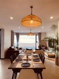 a dining room with a long table and chairs at Beachfront Townhouse - MowenOne in Walvis Bay