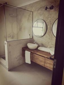 a bathroom with two sinks and a mirror at Beachfront Townhouse - MowenOne in Walvis Bay