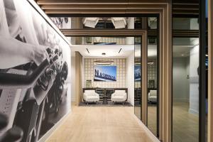 an office lobby with a table and chairs and posters at Loews Nashville Hotel at Vanderbilt Plaza in Nashville