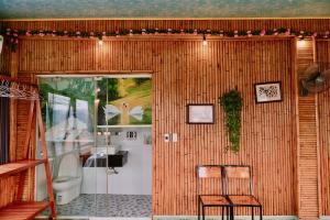 a bathroom with two chairs and a toilet at Hang Mua Bamboo Homestay Ninh Binh in Ninh Binh +59 photos