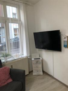 a living room with a flat screen tv on a wall at Ferienwohnung Just City in Wismar