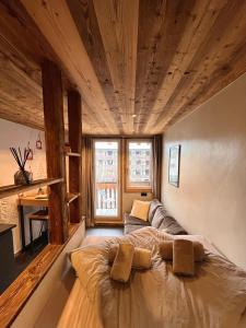 a bedroom with a bed with two pillows on it at Le Nid de l'Aiguille - Au pied de l'Aiguille du midi in Chamonix-Mont-Blanc
