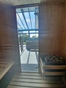 a sauna with a window in a room at Chambres d'Hôtes des Rouets in Fourmies