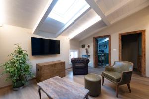 a living room with a flat screen tv on the wall at Nido di Borgo35 in Parma