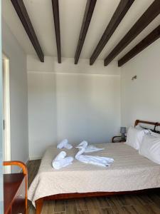 1 dormitorio con 1 cama con toallas en CASA DOS CEDROS en Pico da Pedra
