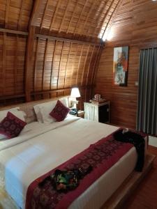 a bedroom with a large bed in a room at The Jiwana Bali Resort in Ungasan