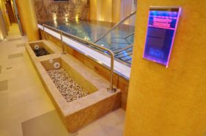 a bathroom with a bathtub with rocks in it at Boutique Hotel Ambiente ****+ in Karlovy Vary