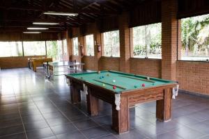 a pool table in a large room with windows at Paradies Hotel Express in Jarinu