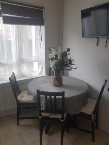 a dining room table with a vase of flowers on it at 4 mereside walk in Manchester