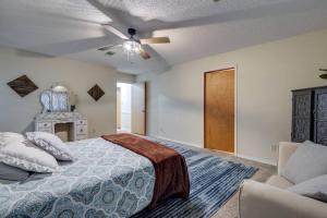 a bedroom with a bed and a ceiling fan at Rustic Flames & 4-Bedroom Comfort in West Monroe