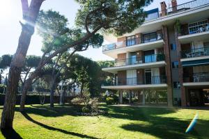 an apartment building with trees in front of it at Wonderful apartment in Gavà. Barcelona in Gavà