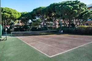 a tennis court with a net on top of it at Wonderful apartment in Gavà. Barcelona in Gavà