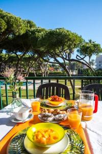 加瓦的住宿－Wonderful apartment in Gavà. Barcelona，餐桌,带食物盘和橙汁杯