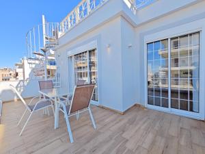 a dining room with a table and chairs on a balcony at Andromaches by Verde Apartments in Athens