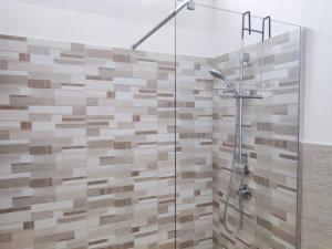 a bathroom with a shower with a glass door at l'Araucaria casa vacanze in Marsala +26 photos