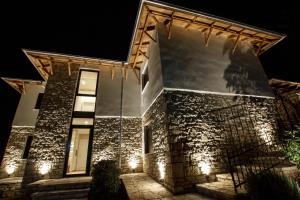a stone building with lights on it at night at Bujtina KOEL in Gjirokastër