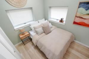 a bedroom with a bed with pillows and a table at [S] Cozy Studio for a Peaceful Lawrence Getaway! in Lawrence