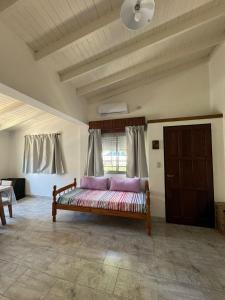 a room with a bed with purple pillows in it at La Francesca-cabañas in Merlo +14 photos